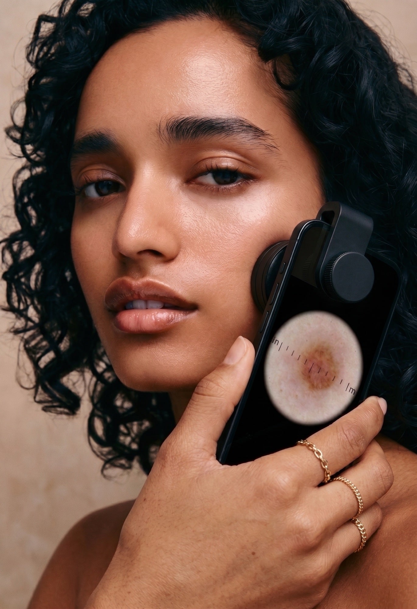 Model positioning the Derm&Root Skin Scope against her cheek