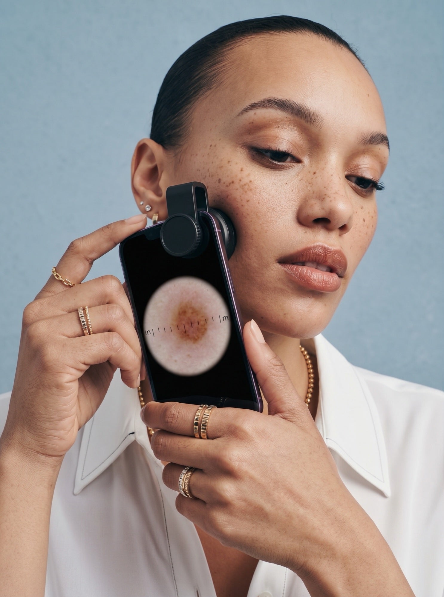 Model completing a guided skin scan with Derm&Root
